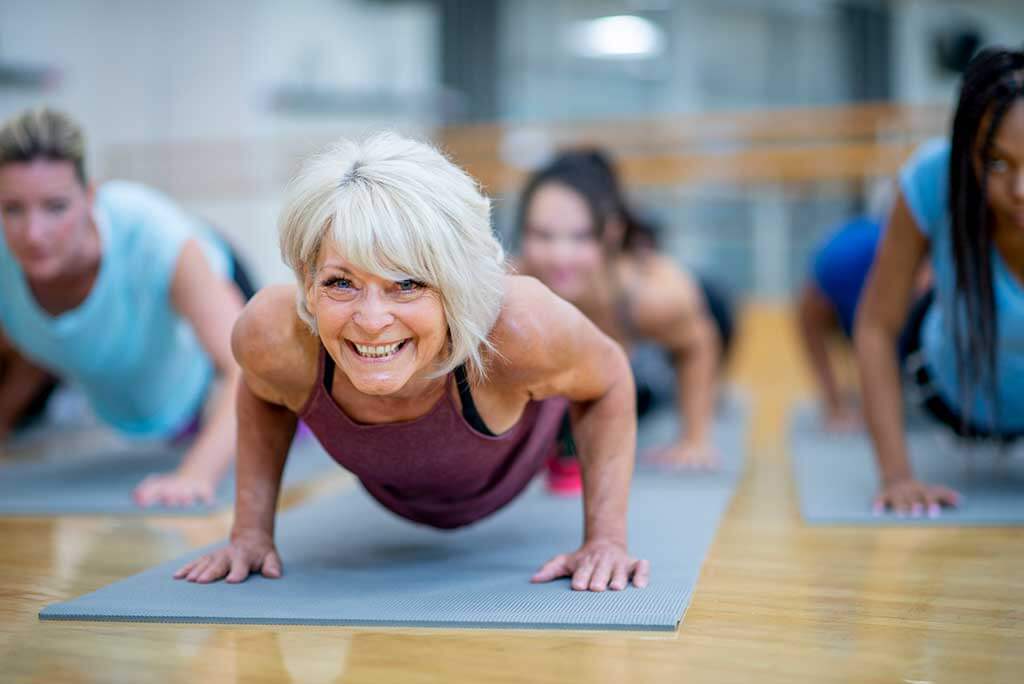 A woman with hearing loss at yoga class.